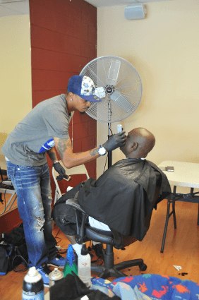 Barber giving a haircut to a customer.
