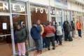 People In Line Outside Of Building
