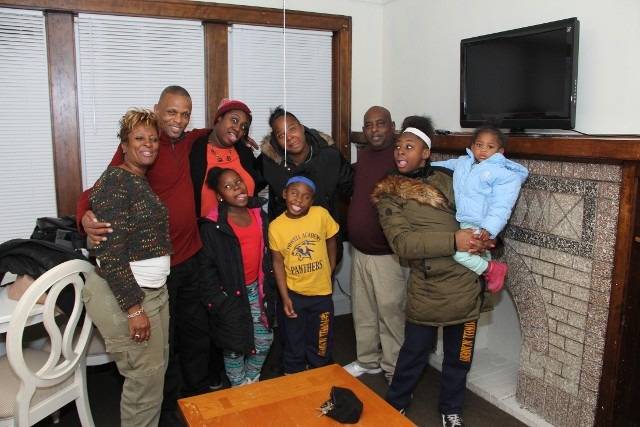Family portrait smiling and posing for photo.