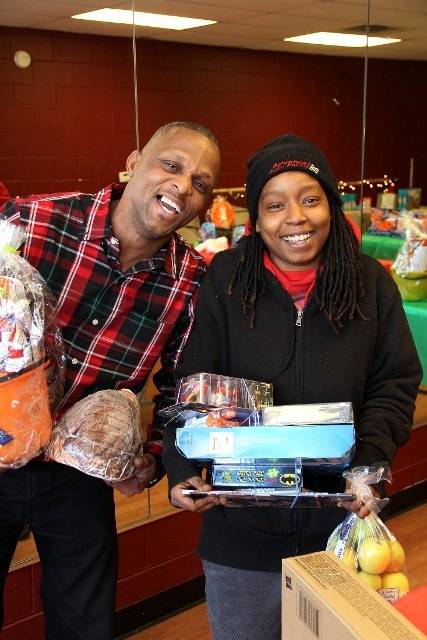 People smiling with gifts.