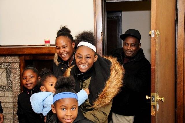Cheerful family gathered at a doorway