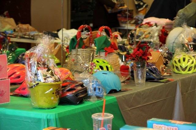Prizes and helmets on a table with holiday decorations.