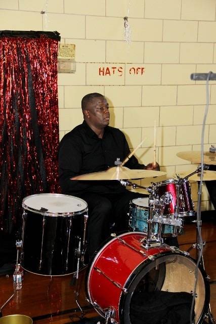 Drummer playing a drum set at an event.