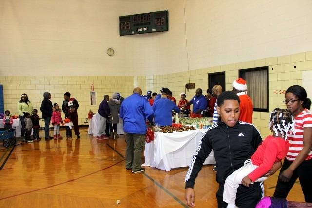 Community event in a gymnasium with food and people.