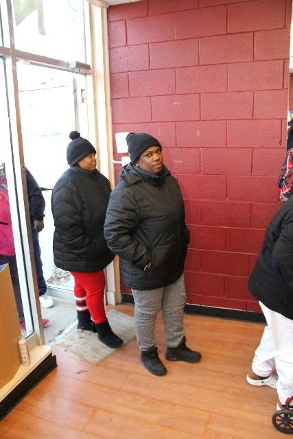 People in winter coats indoors