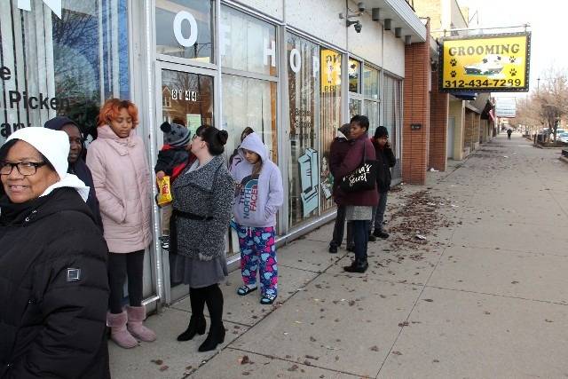 People waiting in line outside a business