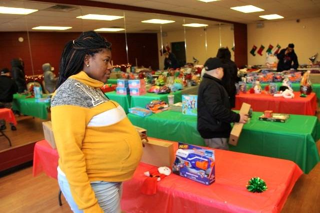 Woman with toys at a Christmas gift event
