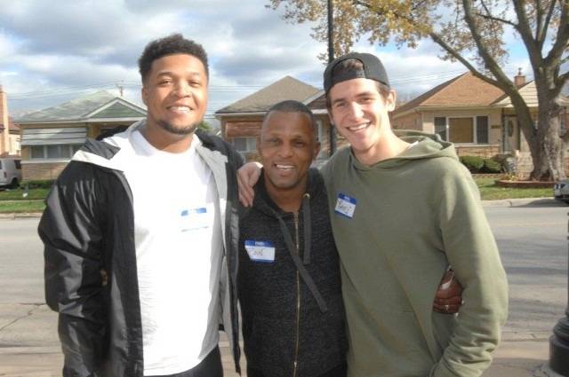 Three people of different ethnicities smiling together