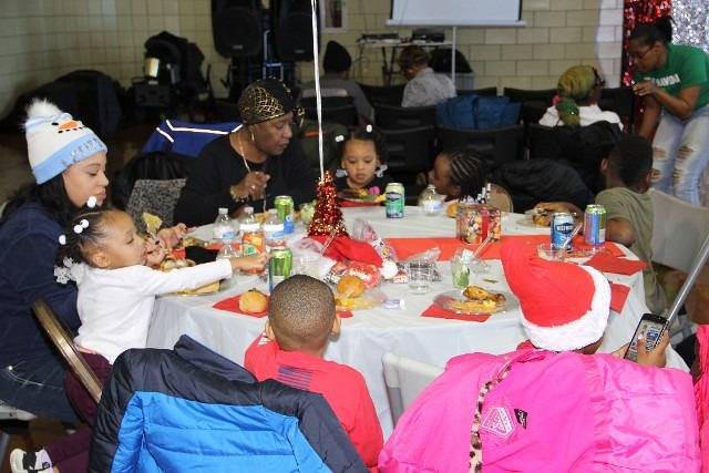 People at a holiday table, eating and celebrating.