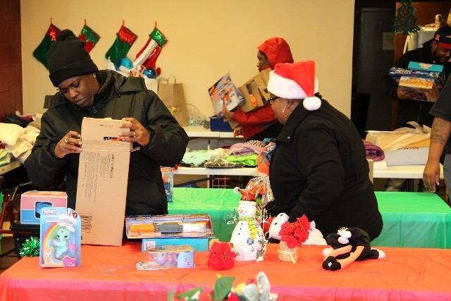 People wrapping Christmas gifts