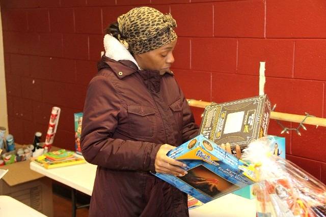 Woman holding two board game boxes.